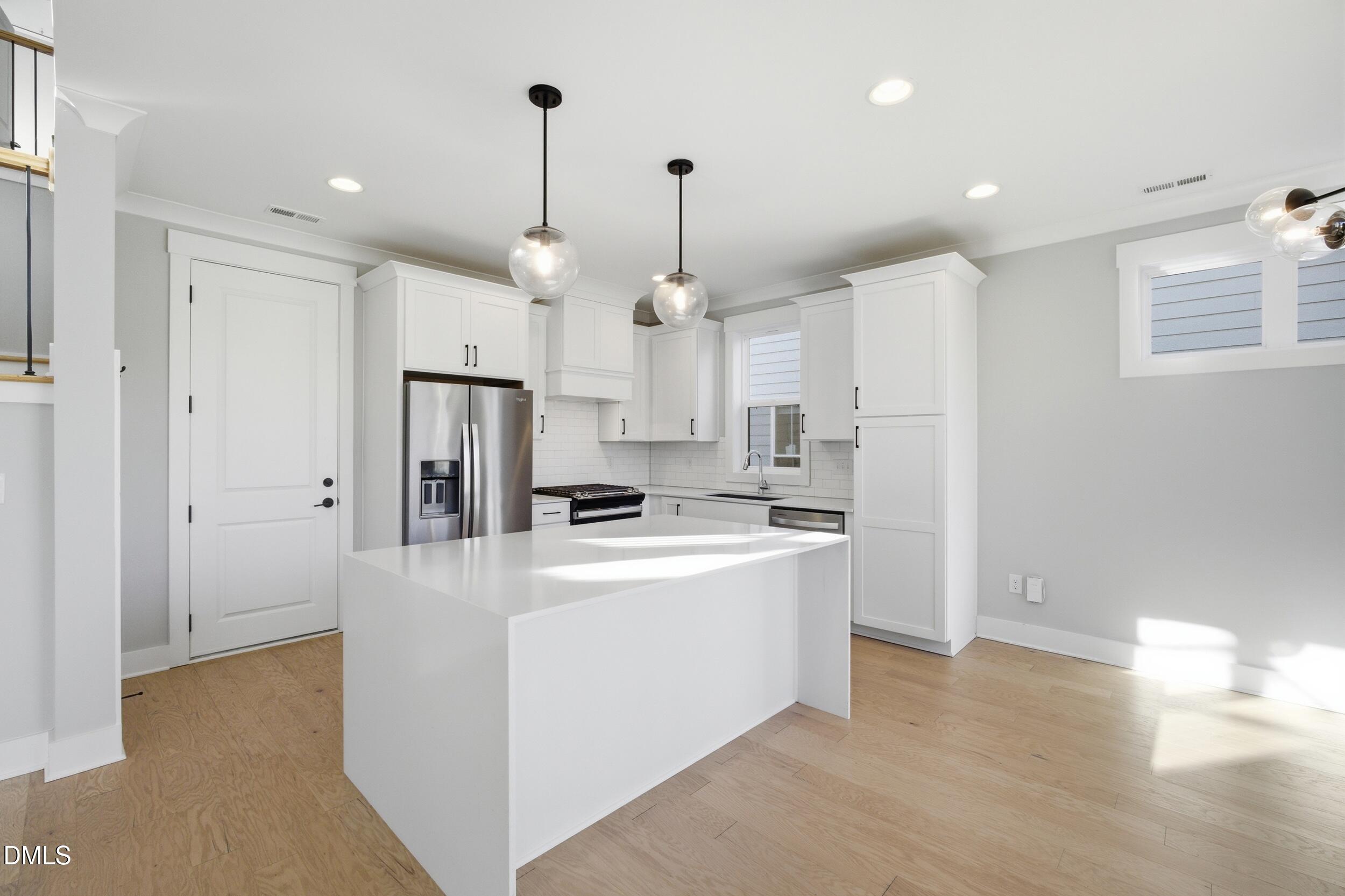 1439 Garner Road Raleigh, NC 27610 - Photo 3 of 37 a kitchen that has a lot of white cabinets and stainless steel appliances