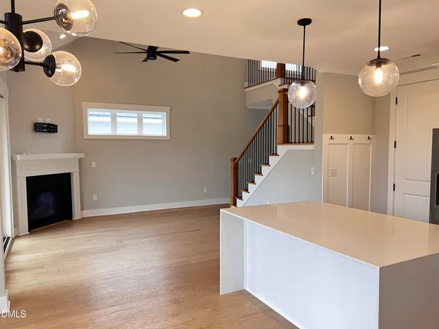 a view of a livingroom with furniture and staircase