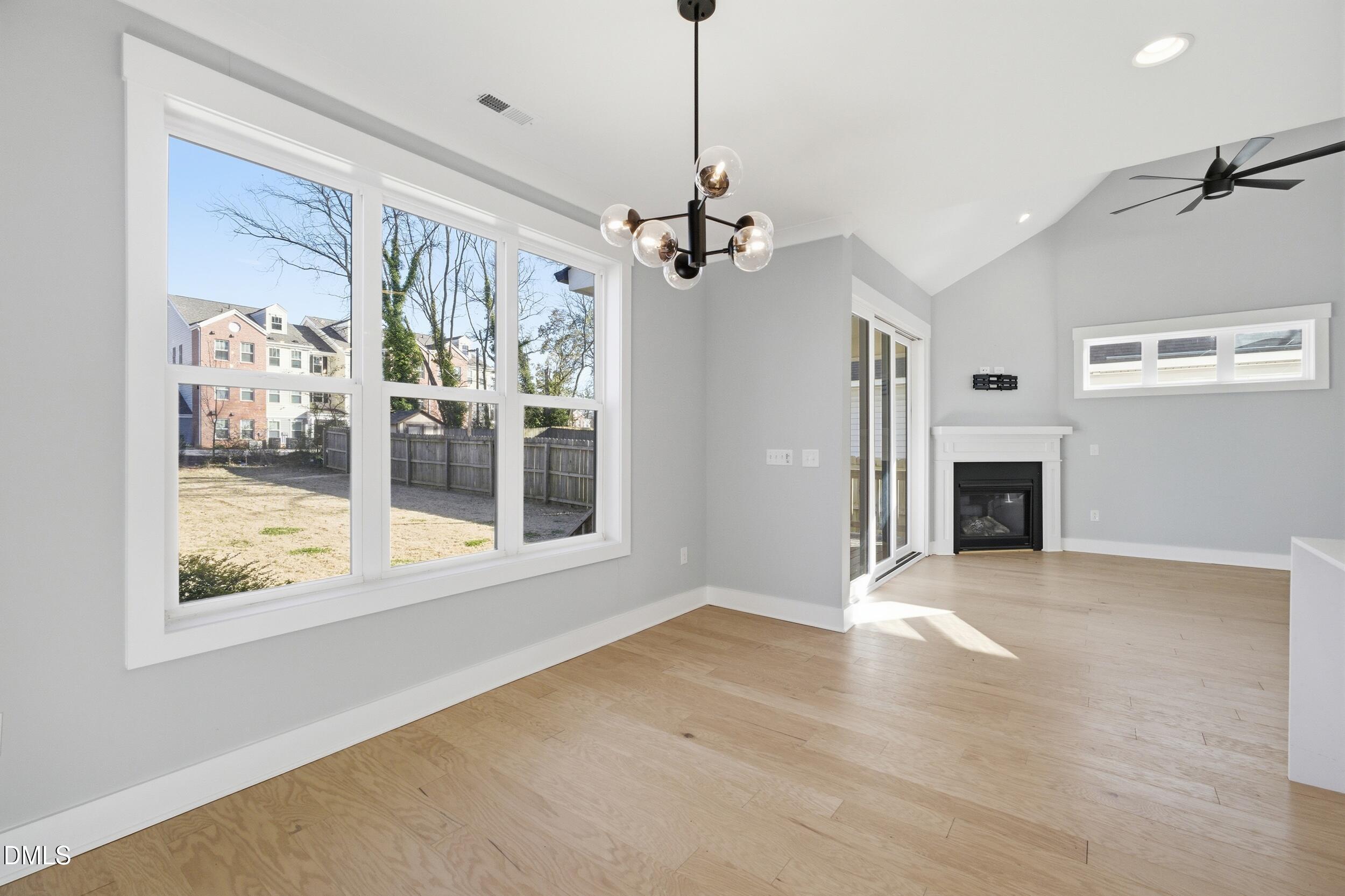 1439 Garner Road Raleigh, NC 27610 - Photo 9 of 37 a view of livingroom with window ceiling fan and front door