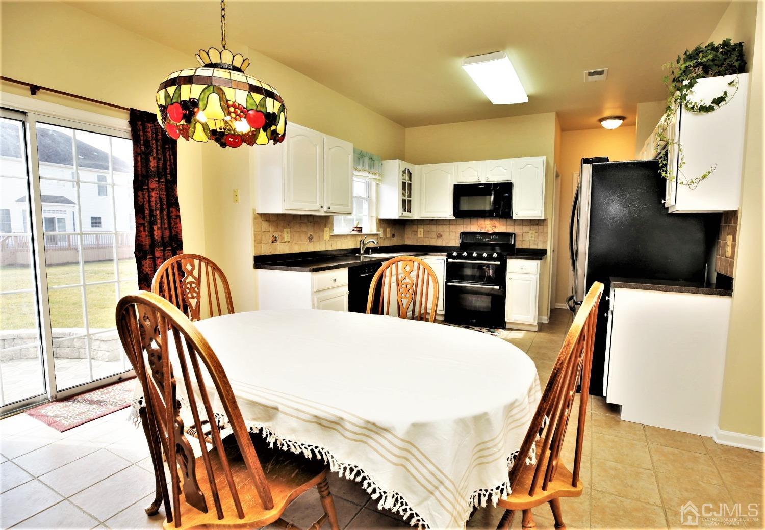 30 Potomac Road Monmouth Junction, NJ 08852 - Photo 12 of 60 a kitchen with stainless steel appliances granite countertop a stove a refrigerator a kitchen island a dining table and chairs