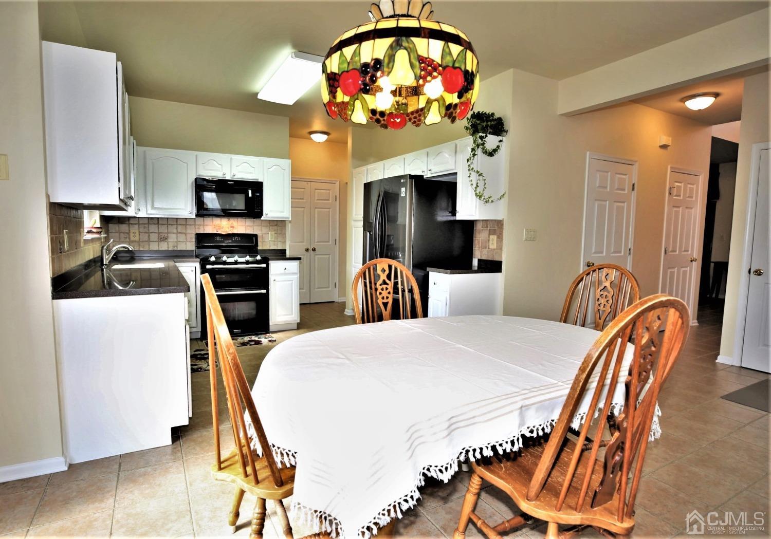 30 Potomac Road Monmouth Junction, NJ 08852 - Photo 13 of 60 a view of kitchen with dining table and chairs