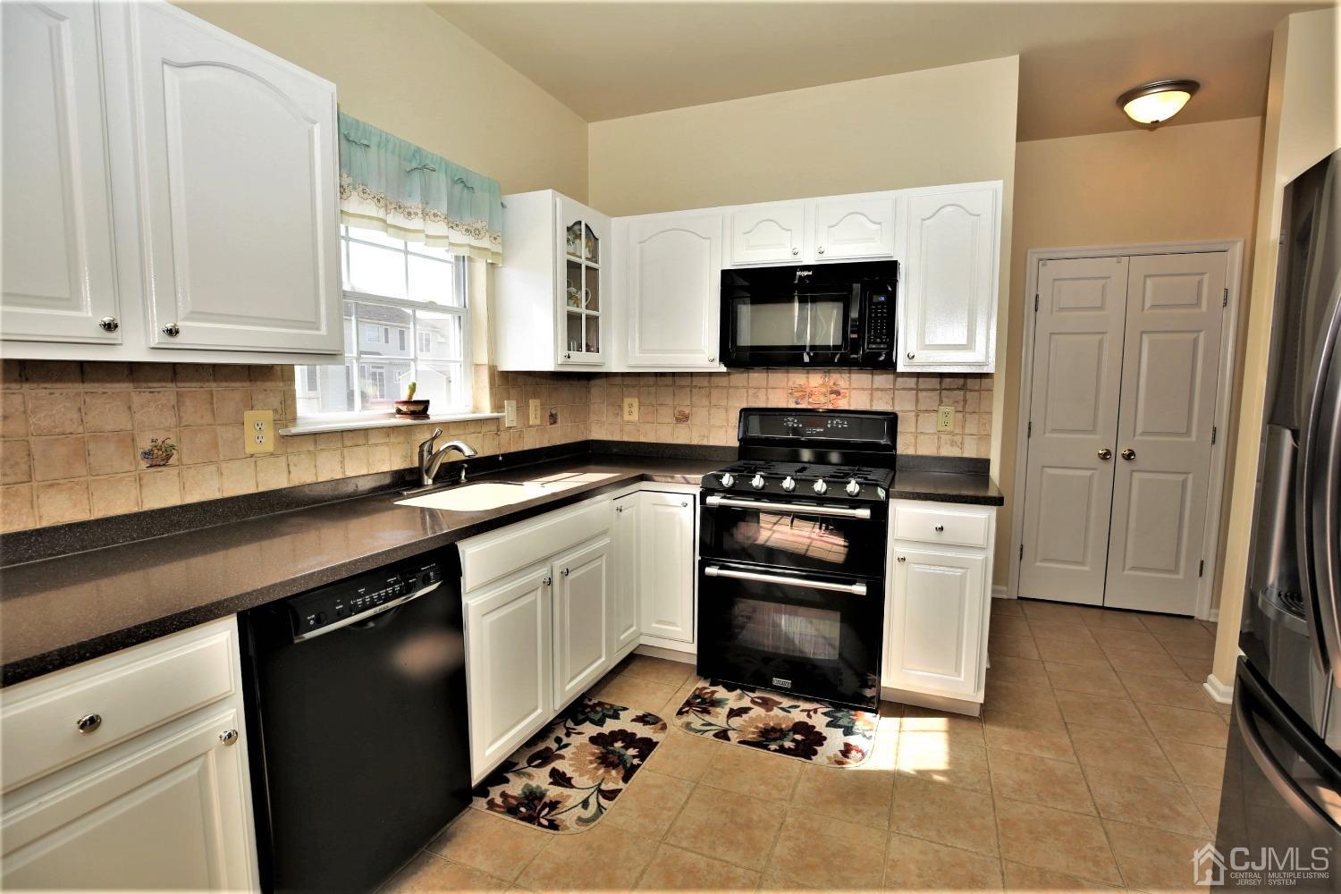 30 Potomac Road Monmouth Junction, NJ 08852 - Photo 14 of 60 a kitchen with a sink stove and microwave