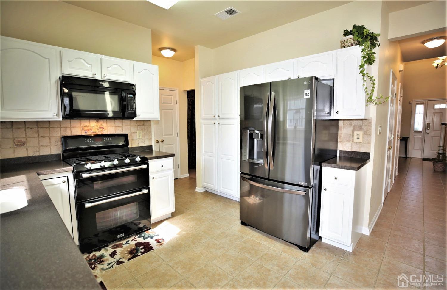 30 Potomac Road Monmouth Junction, NJ 08852 - Photo 15 of 60 a kitchen with stainless steel appliances and granite countertop a refrigerator