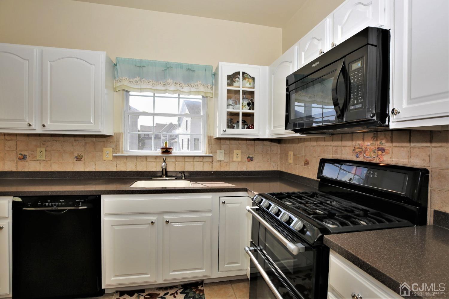 30 Potomac Road Monmouth Junction, NJ 08852 - Photo 16 of 60 a kitchen with stainless steel appliances granite countertop a stove a microwave a sink and cabinets
