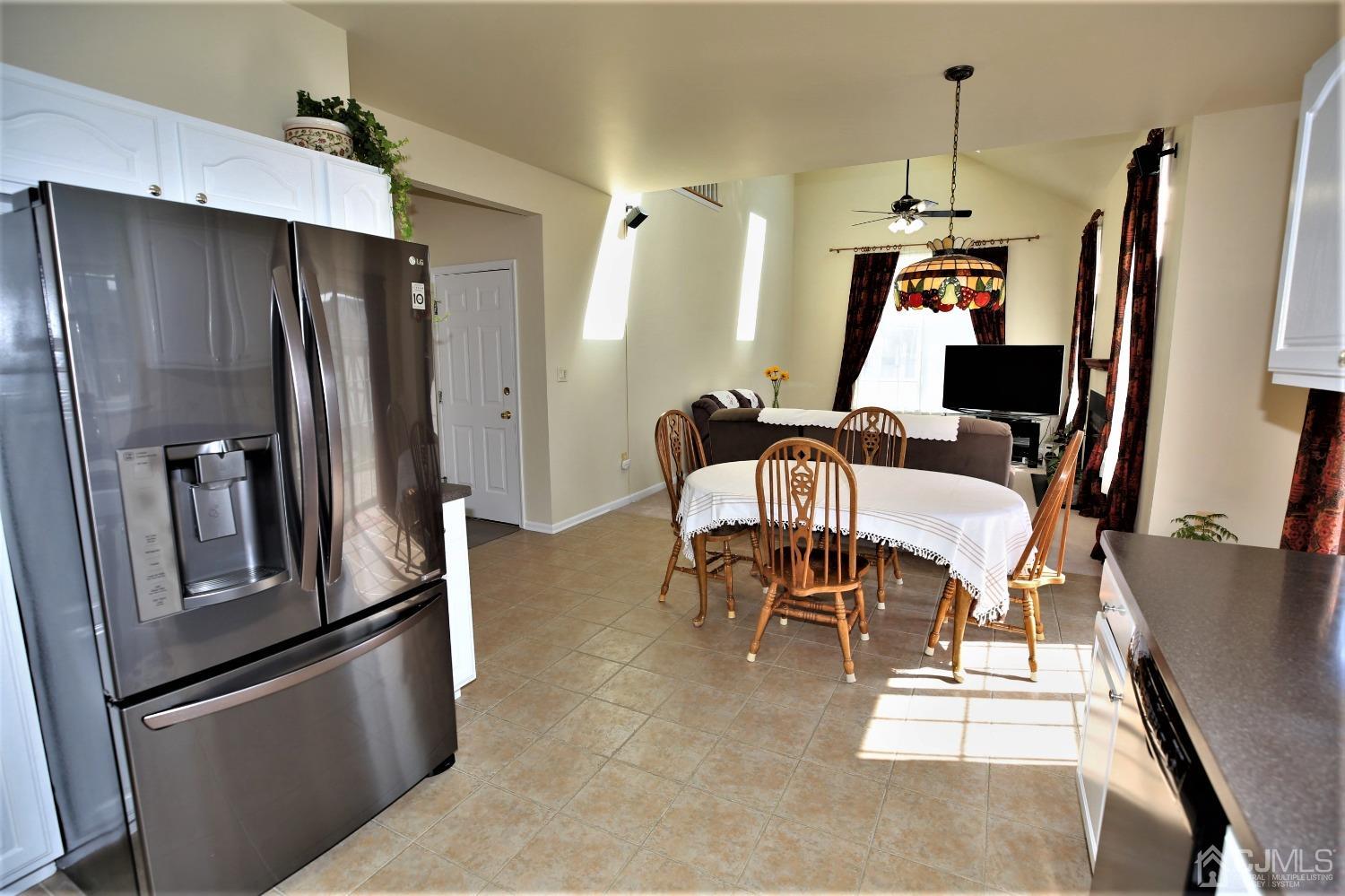 30 Potomac Road Monmouth Junction, NJ 08852 - Photo 17 of 60 a kitchen with stainless steel appliances kitchen island a table chairs and refrigerator