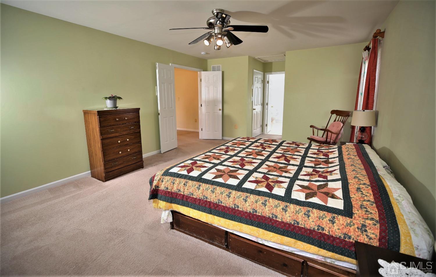 30 Potomac Road Monmouth Junction, NJ 08852 - Photo 32 of 60 a bedroom with a bed and a chandelier