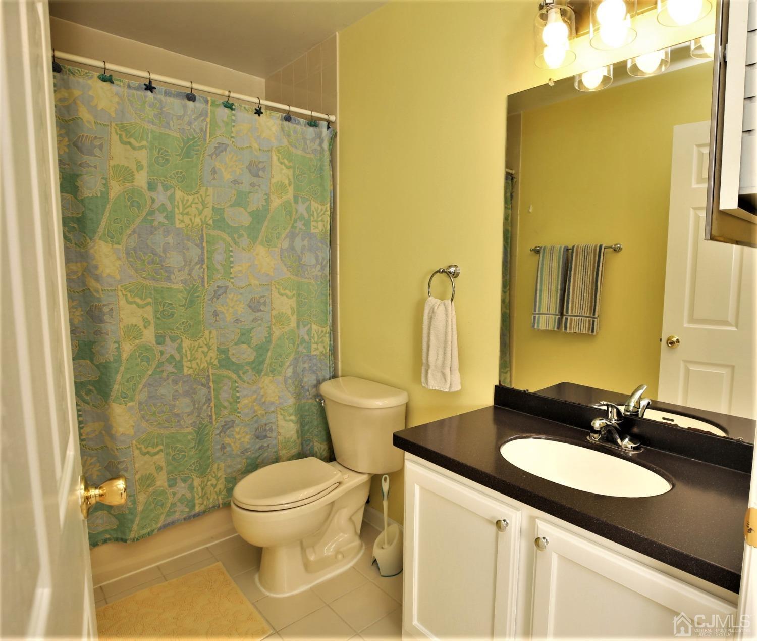 30 Potomac Road Monmouth Junction, NJ 08852 - Photo 44 of 60 a bathroom with a granite countertop sink toilet and shower