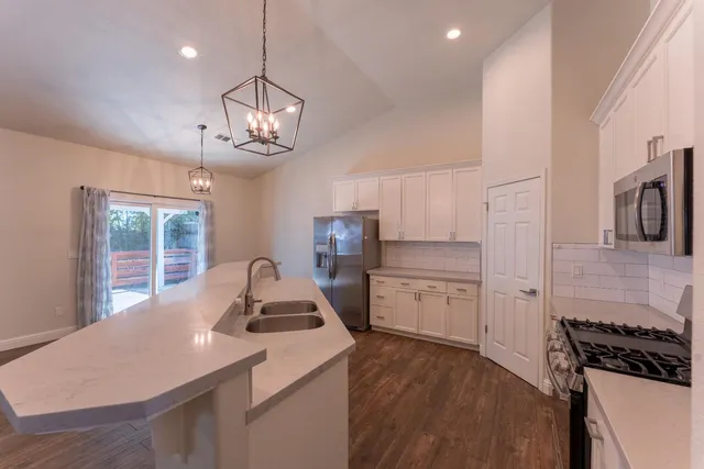 a kitchen with a sink stove and refrigerator