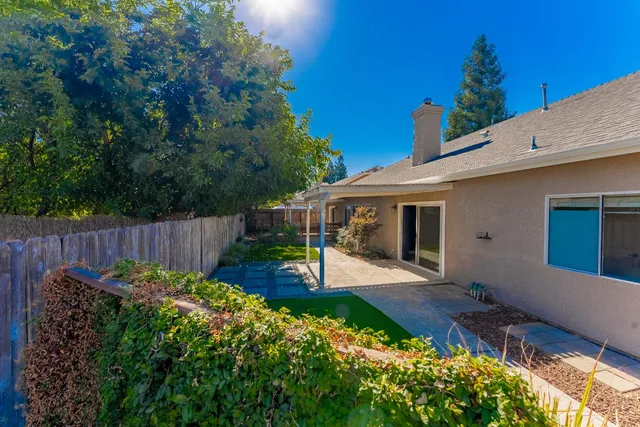 a view of a backyard with plants and a patio
