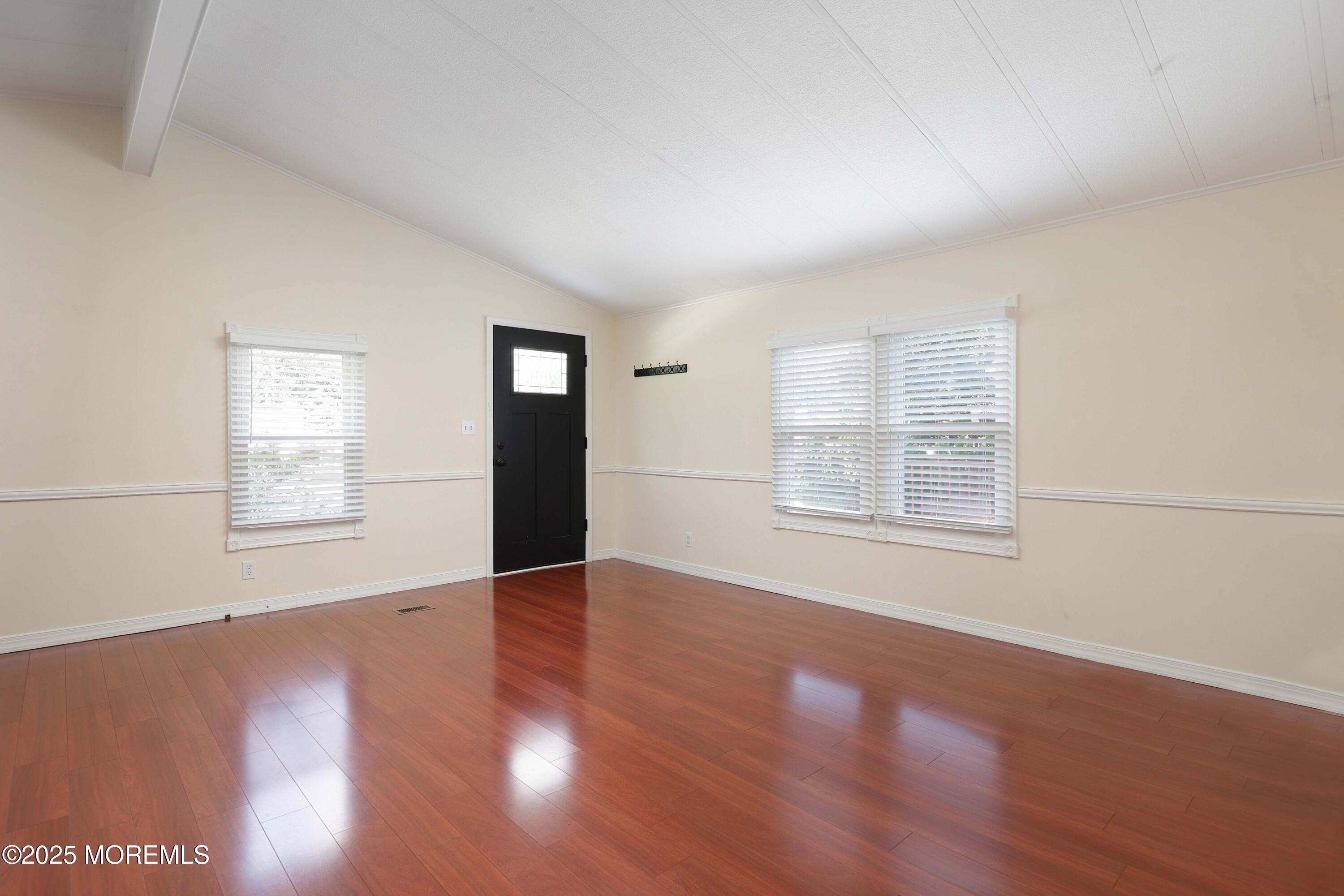 15 Cedar Court Manalapan, NJ 07726 - Photo 11 of 30 a view of an empty room with wooden floor and a window