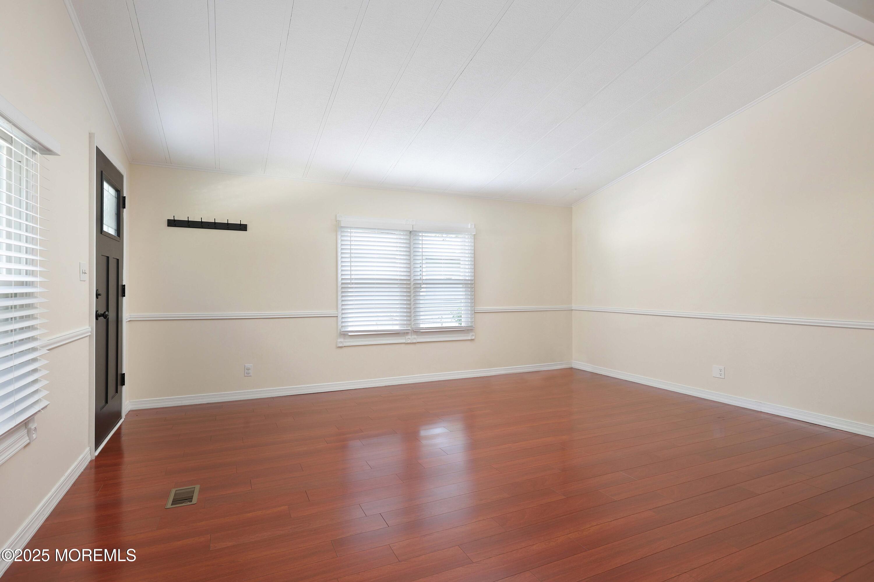 15 Cedar Court Manalapan, NJ 07726 - Photo 13 of 30 an empty room with wooden floor and windows
