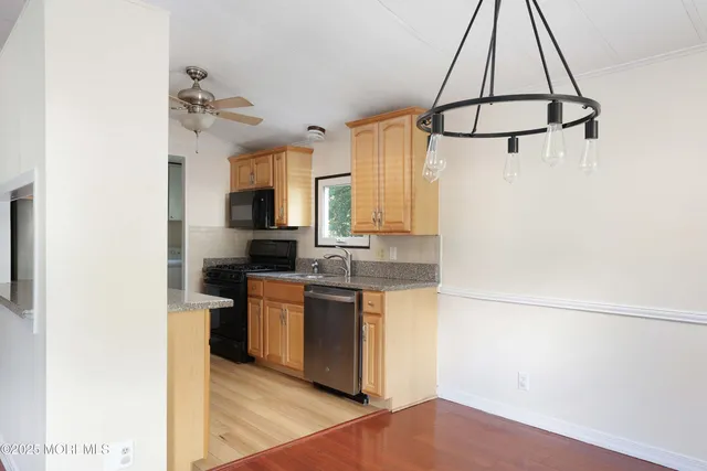 a kitchen with stainless steel appliances a sink stove and refrigerator