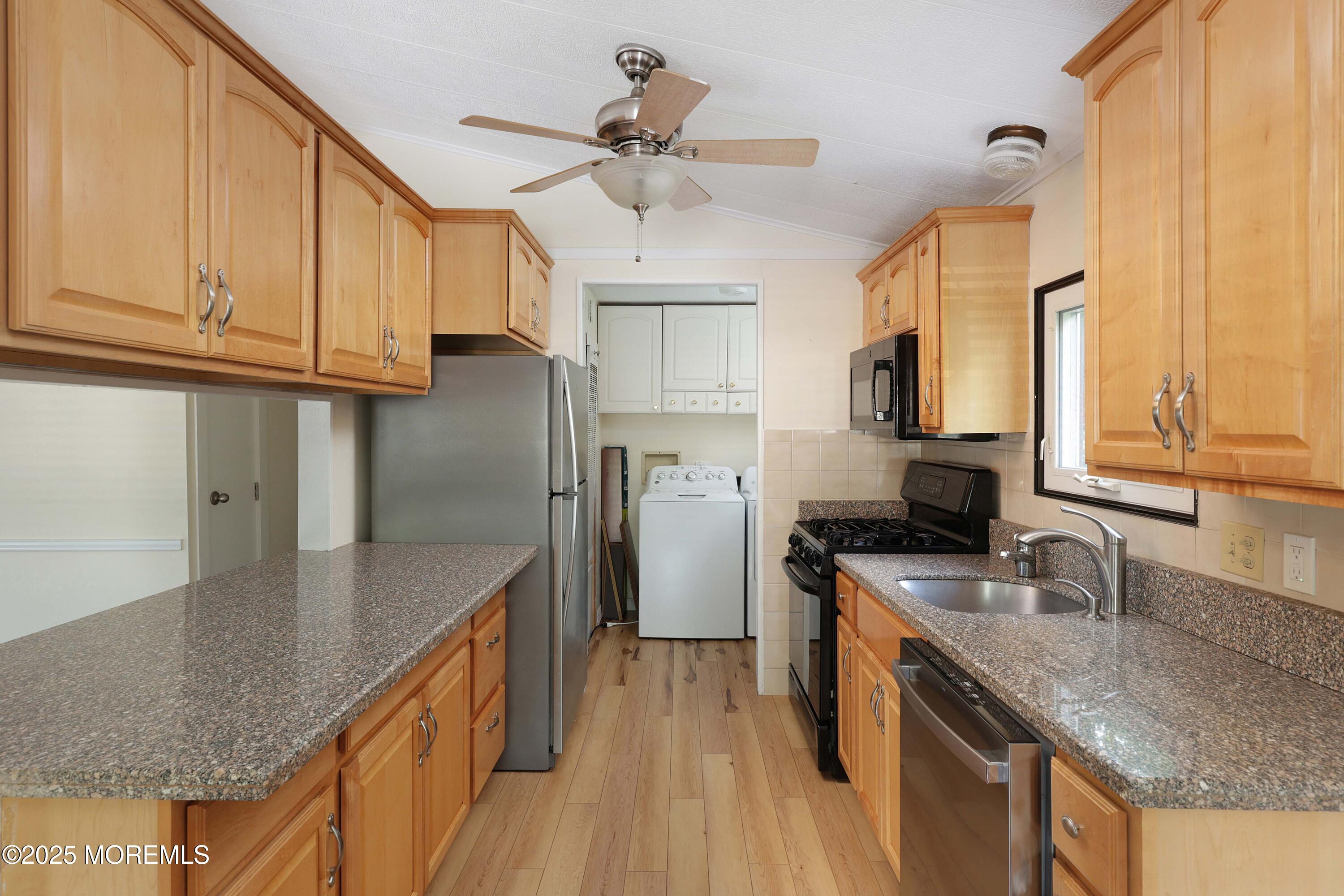 15 Cedar Court Manalapan, NJ 07726 - Photo 18 of 30 a kitchen with granite countertop a sink a counter space appliances and cabinets