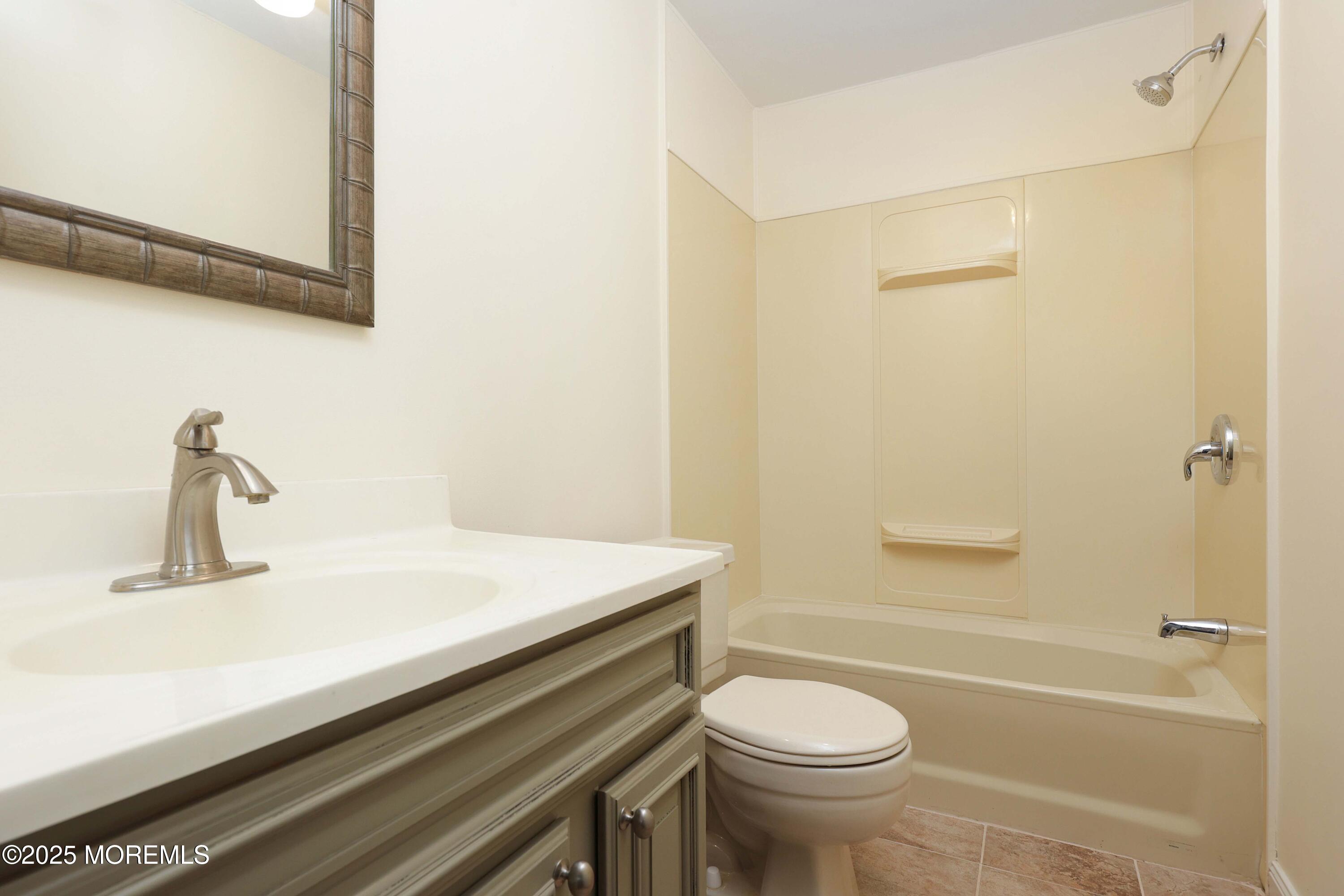 15 Cedar Court Manalapan, NJ 07726 - Photo 24 of 30 a bathroom with a sink a toilet and shower
