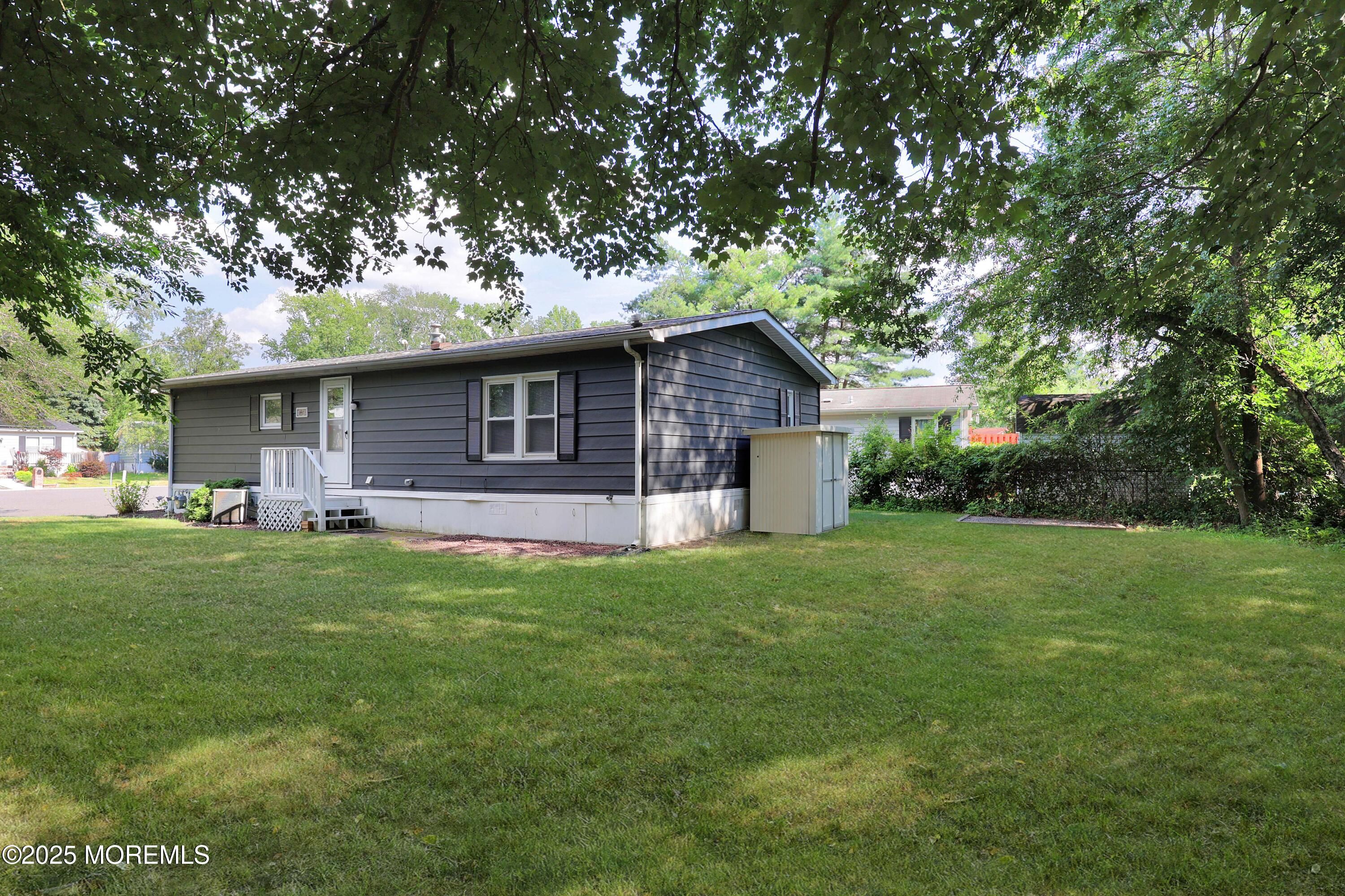 15 Cedar Court Manalapan, NJ 07726 - Photo 8 of 30 a front view of a house with a garden