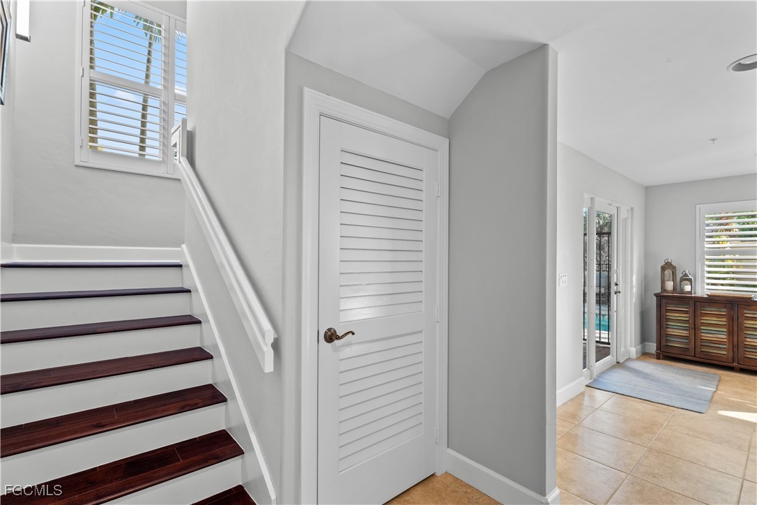 1104 6th Street South, Unit 1 Naples, FL 34102 - Photo 14 of 47 a view of a hallway with windows and stairs