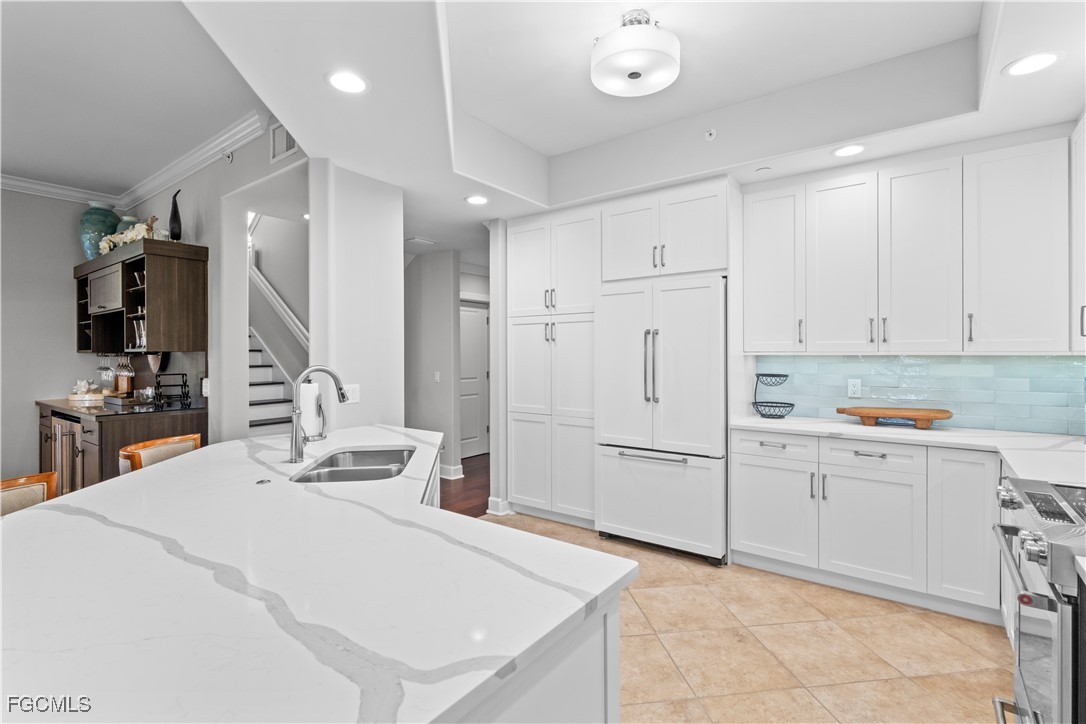 1104 6th Street South, Unit 1 Naples, FL 34102 - Photo 16 of 47 a kitchen with white cabinets and refrigerator