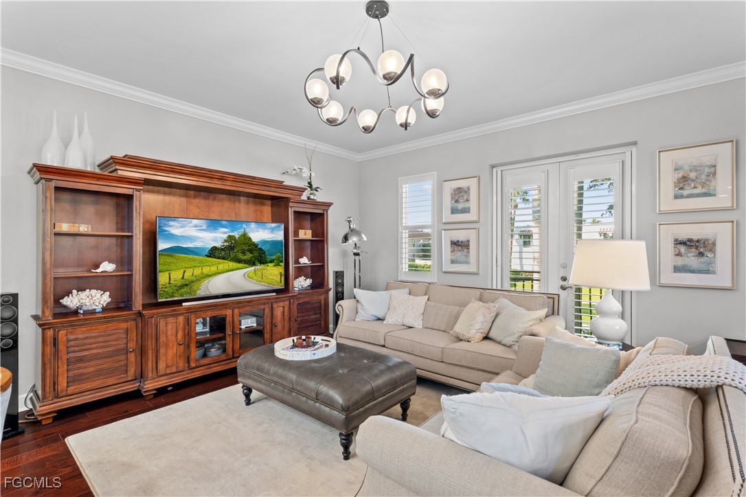 1104 6th Street South, Unit 1 Naples, FL 34102 - Photo 21 of 47 a living room with furniture and a flat screen tv