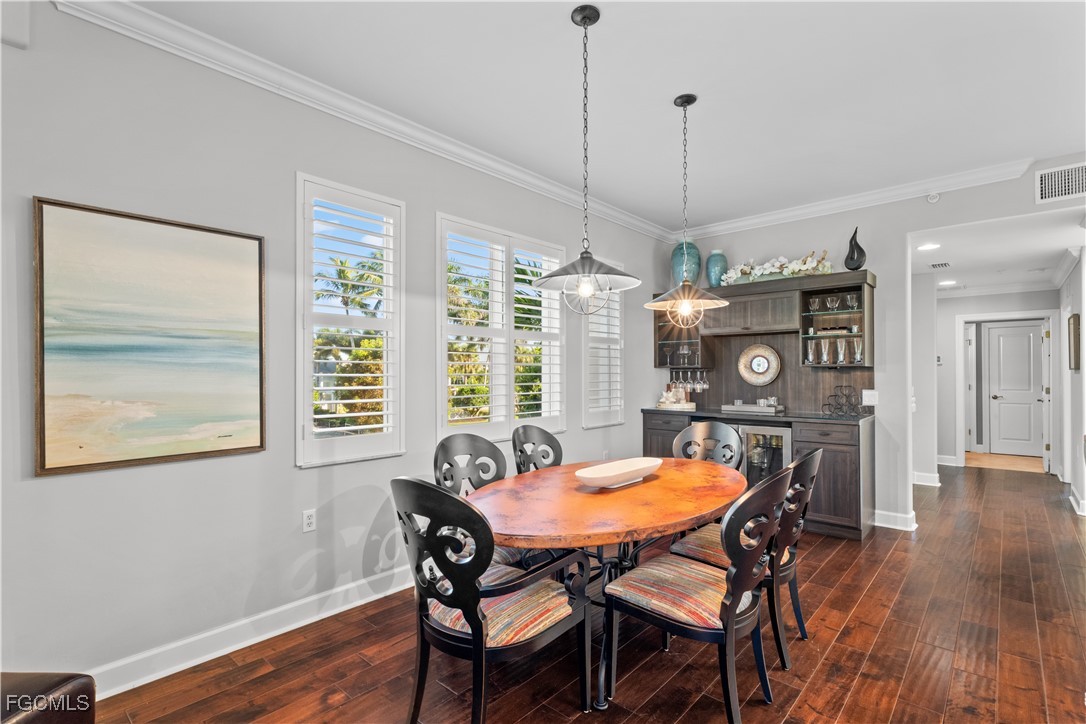 1104 6th Street South, Unit 1 Naples, FL 34102 - Photo 22 of 47 a view of a dining room with furniture window and wooden floor