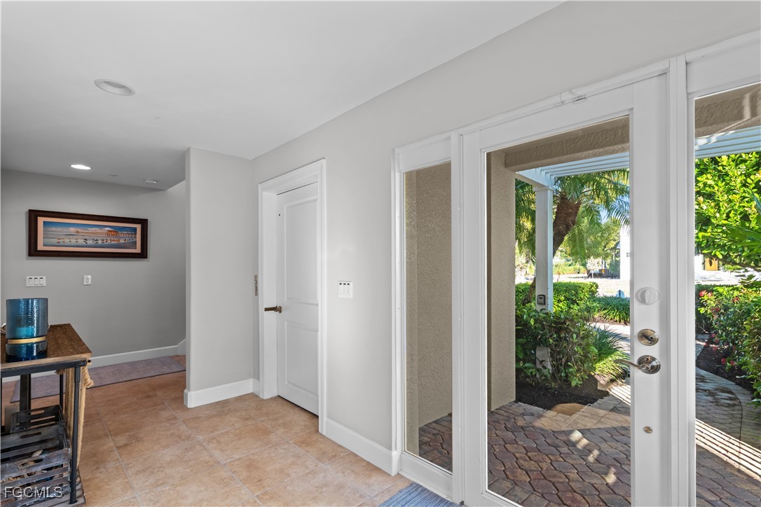 1104 6th Street South, Unit 1 Naples, FL 34102 - Photo 3 of 47 a view of a big room with windows and entrance