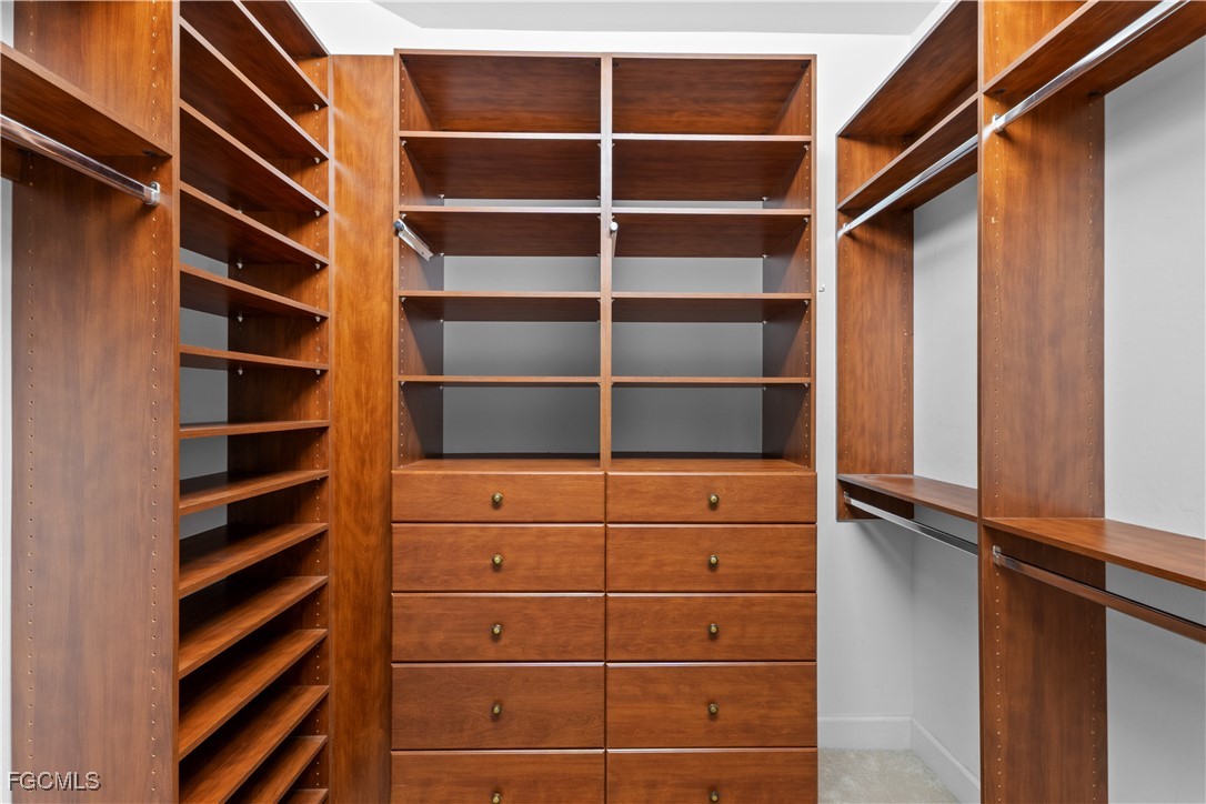 1104 6th Street South, Unit 1 Naples, FL 34102 - Photo 35 of 47 a view of walk in closet with empty racks
