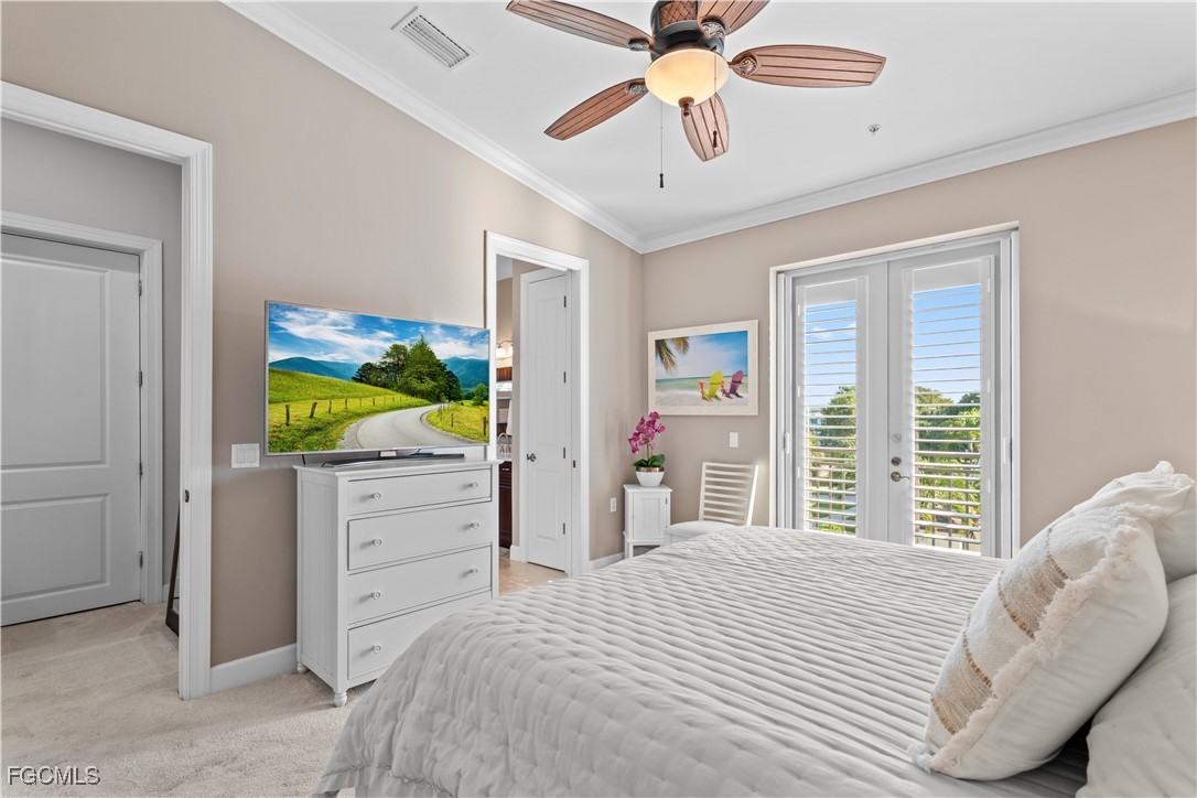 1104 6th Street South, Unit 1 Naples, FL 34102 - Photo 39 of 47 a bedroom with a bed and a chandelier