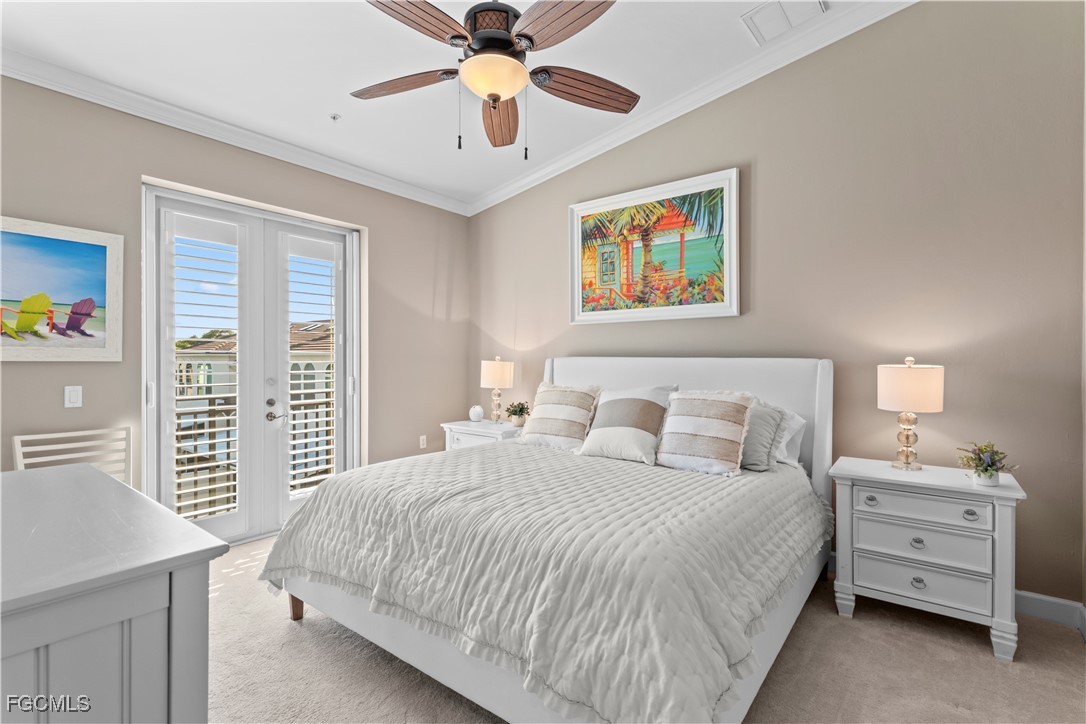 1104 6th Street South, Unit 1 Naples, FL 34102 - Photo 40 of 47 a bedroom with a bed and a chandelier