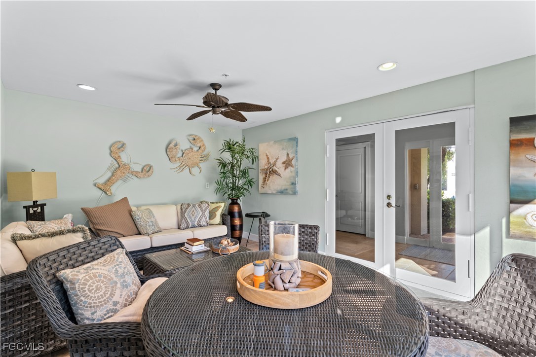 1104 6th Street South, Unit 1 Naples, FL 34102 - Photo 7 of 47 a living room with furniture and a dining table with garden view