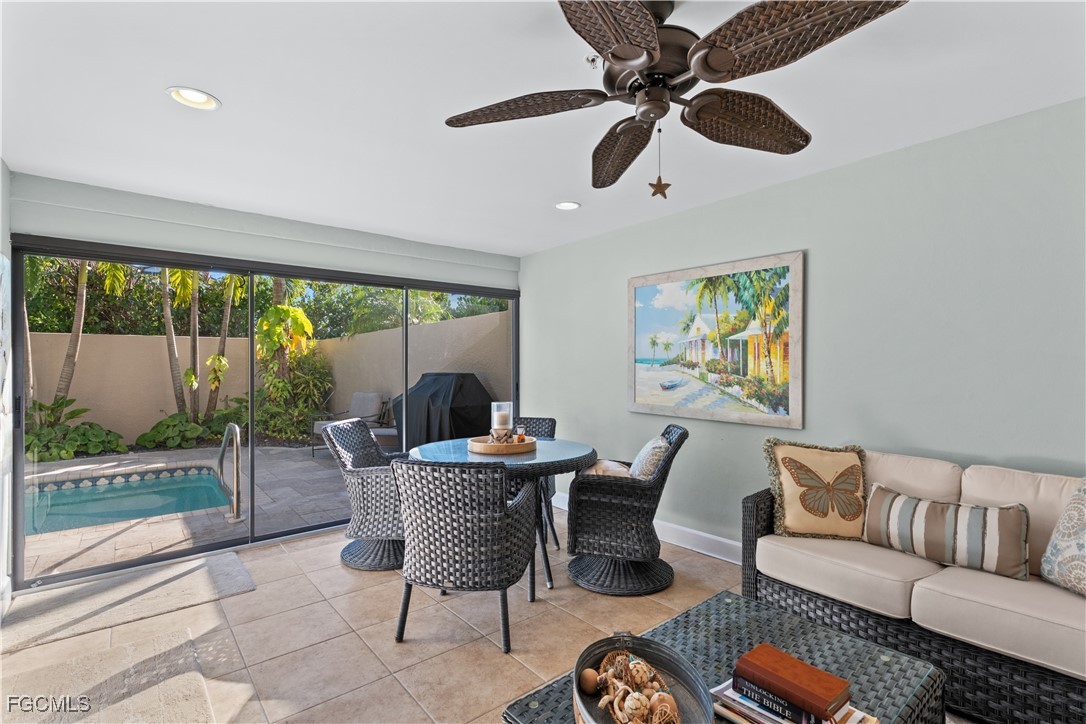 1104 6th Street South, Unit 1 Naples, FL 34102 - Photo 8 of 47 a living room with furniture and a floor to ceiling window
