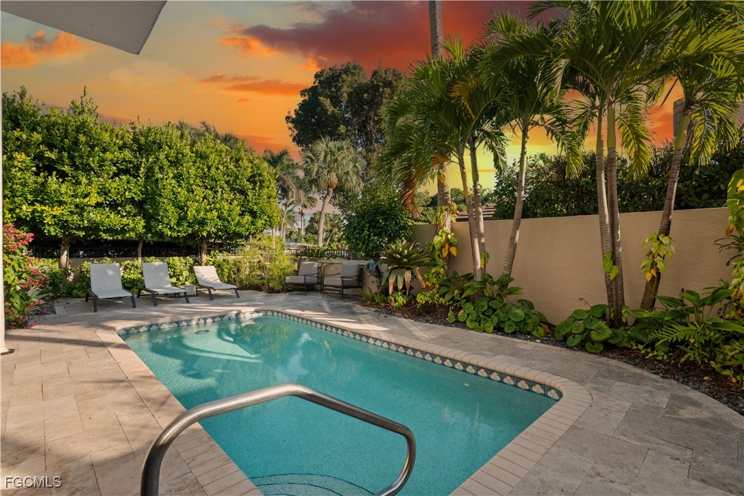 1104 6th Street South, Unit 1 Naples, FL 34102 - Photo 10 of 47 a view of a swimming pool with a patio