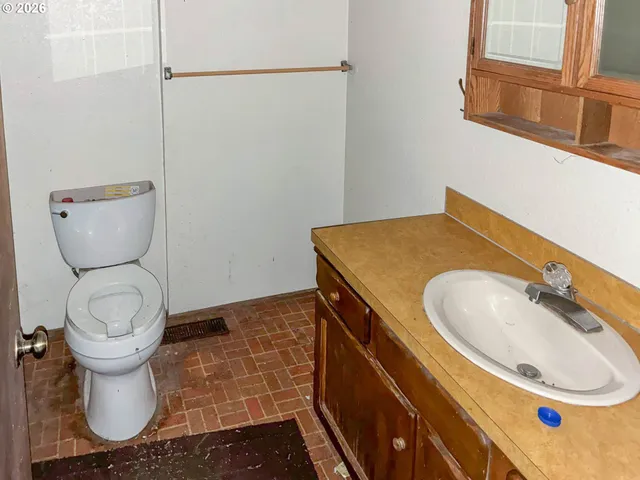 a bathroom with a sink toilet and mirror