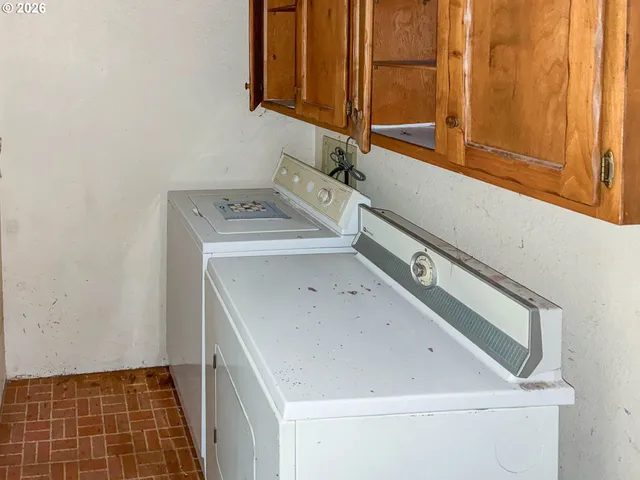 a utility room with a sink washer and dryer