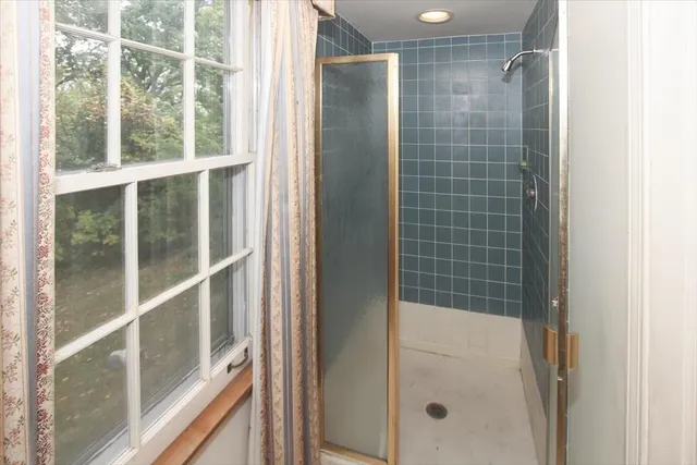 a bathroom with a glass shower door