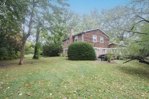 a view of a house with a backyard