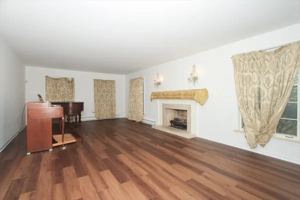 a view of a livingroom with a fireplace and a window