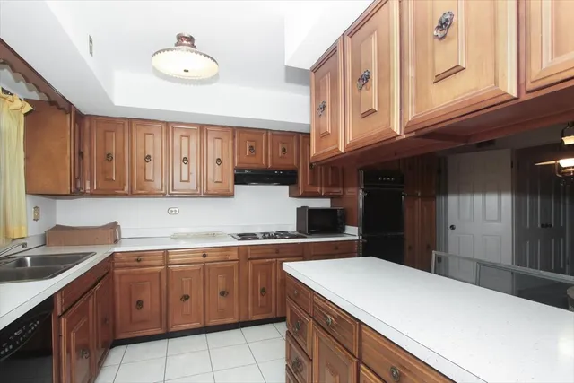 a kitchen that has a sink and a stove in it