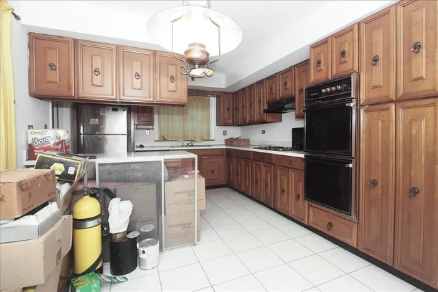 a kitchen with stainless steel appliances granite countertop a sink and cabinets