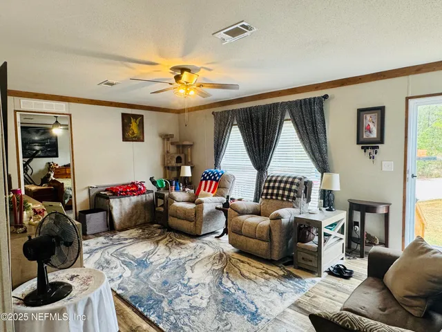 a living room with furniture a rug and a window