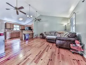 a living room with furniture and a wooden floor