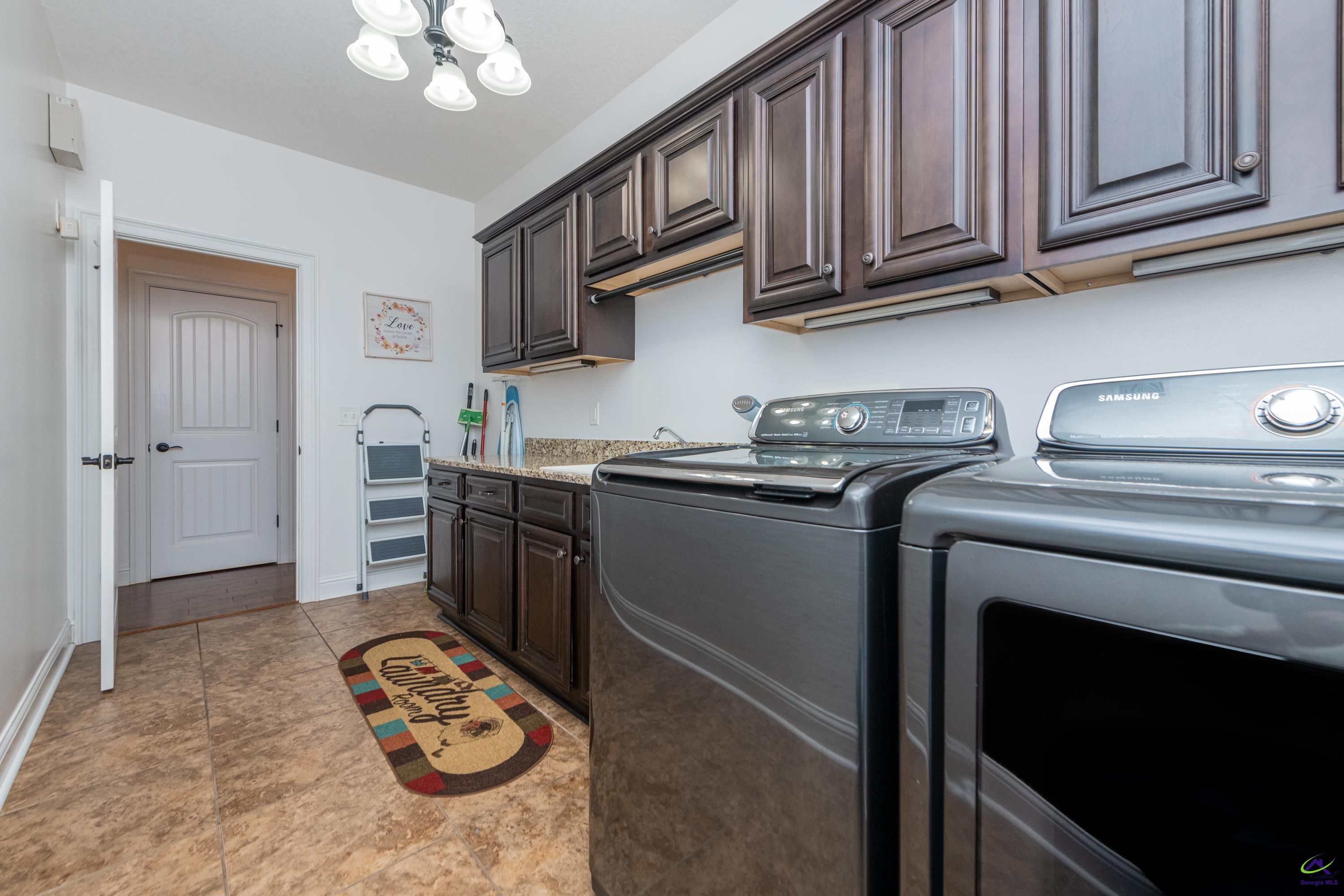 405 Old Bridge Road Warner Robins, GA 31088 - Photo 27 of 58 a kitchen with stainless steel appliances granite countertop a sink stove and cabinets