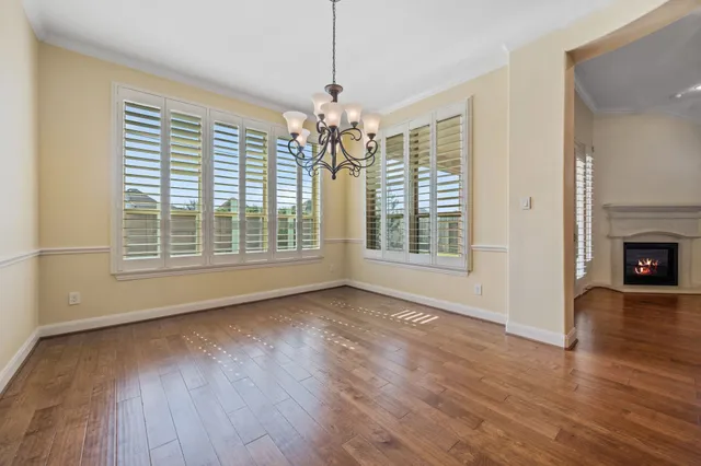 a view of livingroom with window hardwood floor and kitchen view