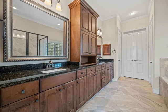 a kitchen with granite countertop a sink and cabinets