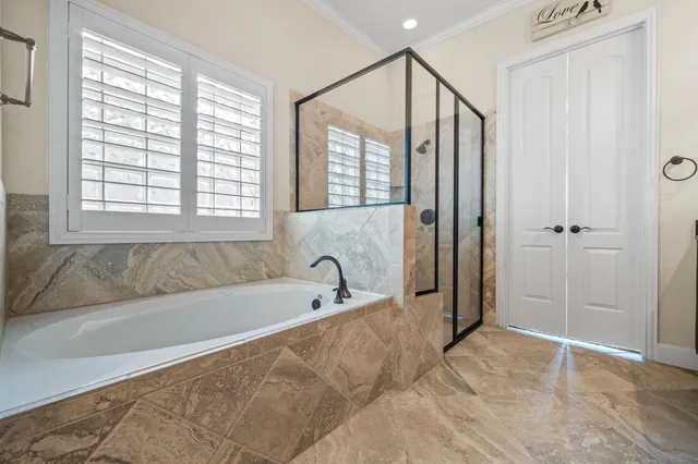 a bathroom with a bathtub and a shower