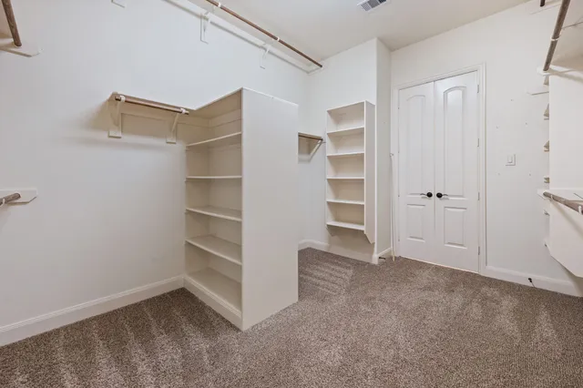 a view of an empty walk in closet