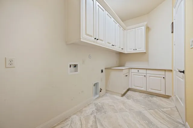 a view of a kitchen with white cabinets