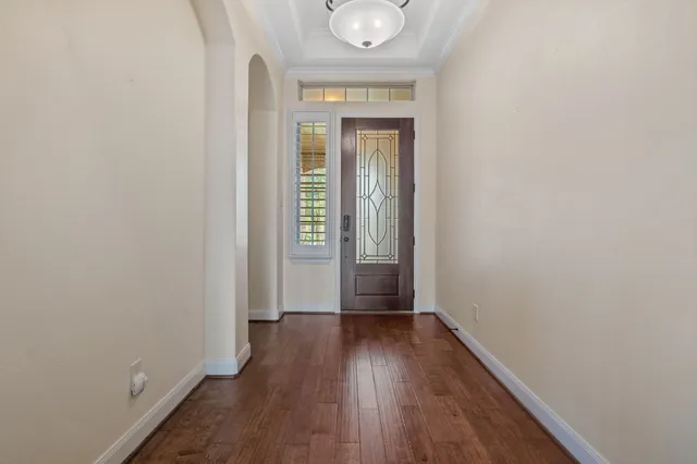 a view of a hallway with wooden floor