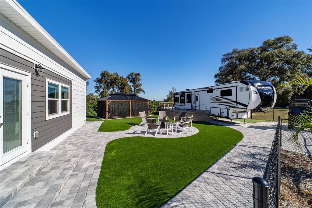 15991 Northeast 243rd Place Road, Unit 351 & 352 Fort McCoy, FL 32134 - Photo 12 of 86 a view of a house with backyard sitting area and garden