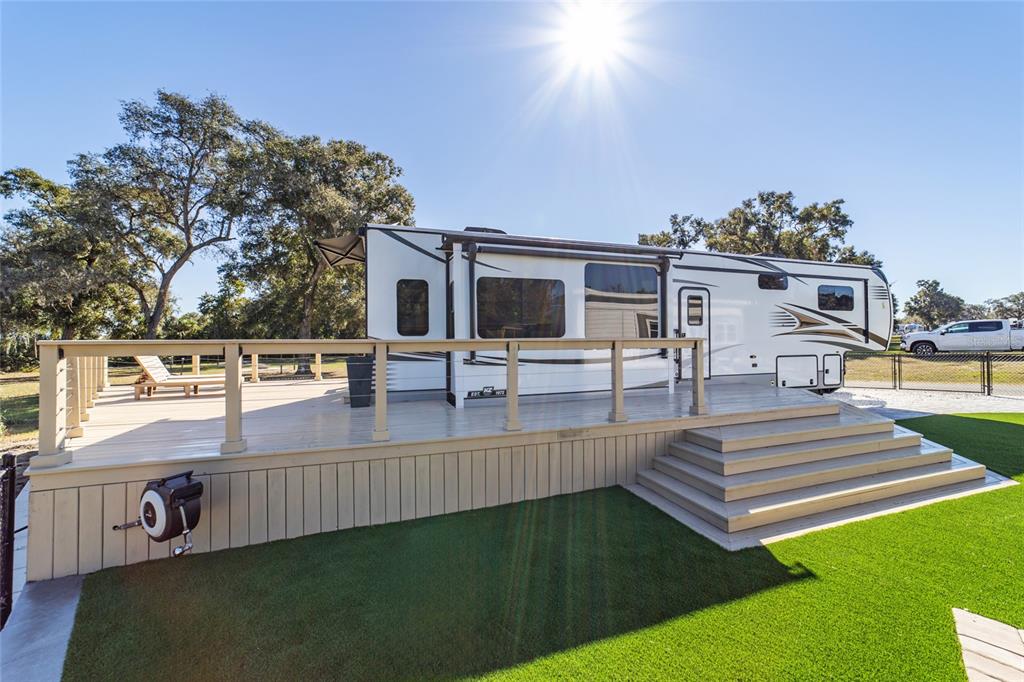15991 Northeast 243rd Place Road, Unit 351 & 352 Fort McCoy, FL 32134 - Photo 30 of 86 a view of a patio with table and chairs with wooden floor and fence