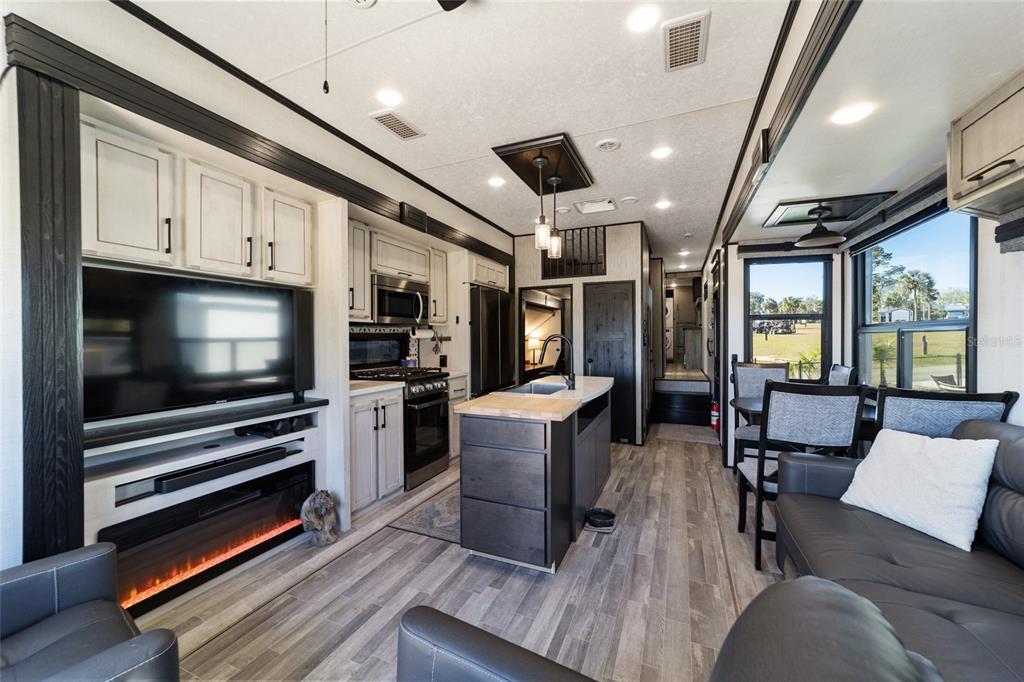 15991 Northeast 243rd Place Road, Unit 351 & 352 Fort McCoy, FL 32134 - Photo 36 of 86 a kitchen with stainless steel appliances kitchen island granite countertop a stove and a refrigerator