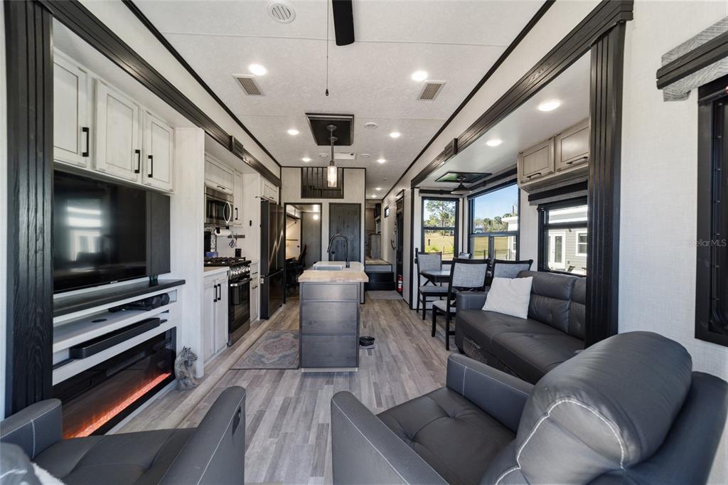 15991 Northeast 243rd Place Road, Unit 351 & 352 Fort McCoy, FL 32134 - Photo 38 of 86 a living room with furniture and a flat screen tv